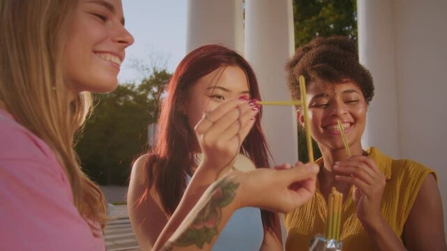 Females opening package of snacks and enjoying sweets