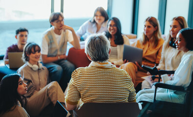 Multigenerational group gathered for a learning session with diverse students listening to an...