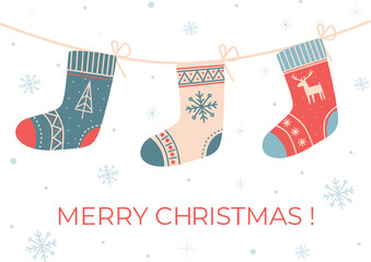 Christmas socks hanging on rope on white background with snowflakes. Christmas greeting card with with stockings.