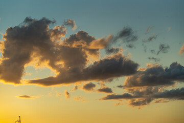 Sky background with clot illuminated by the sunset sunlight 