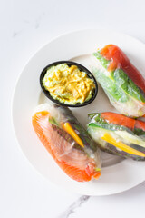 Savor the authentic taste of Vietnamese spring rolls with rice paper, fresh vegetables, salmon, and fish sauce, blending the best of Asian and Thai cuisine in a healthy, refreshing meal