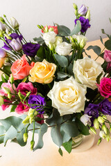 A beautiful bouquet of vibrant roses, eucalyptus, and delicate eustoma in white, pink, and purple hues, perfect for a summer anniversary or birthday celebration