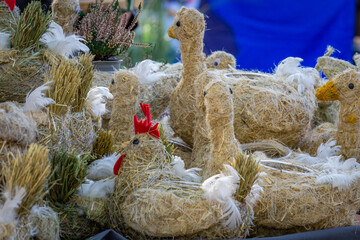 handmade decorations at a village market. hens made by hand from straw. © Adam