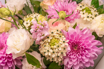Bouquet of flowers with pink roses, chrysanthemum and freesia flower in a vase isolated on a white background.