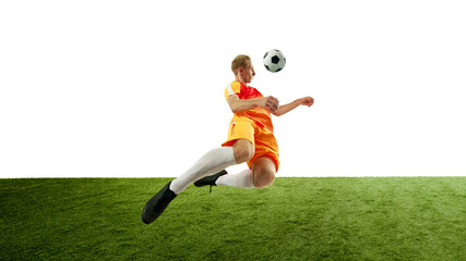 With ball soaring, young male player makes high kick, demonstrating his incredible flexibility and control over game. Dynamic photo. Concept of competition, sport games, movement, energy. Ad.