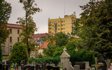 city ​​cemetery against the background of apartment blocks and urban architecture