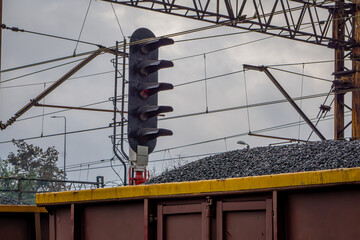 rail transport of coal and coal dust in freight wagons. non-ecological winter fuel. freight train standing at the railway station. wagons full of coal. view of the railway electrical network, high vol © Adam