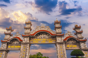 Stone gate Thap Xa Loi at Linh Ung Pagoda in Da Nang in Vietnam in Asia at sunset