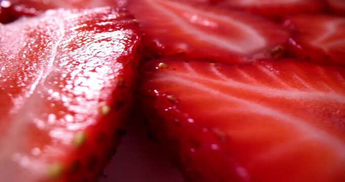 Slices of fresh strawberries and spinning in circle. Fresh delicious strawberries macro