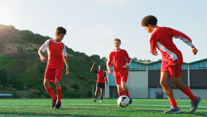 Group Of Male High School Students With Coach Playing In Soccer Team