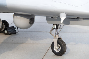 A medium-altitude long-endurance unmanned combat aerial vehicle. Camera and chassis, close-up.