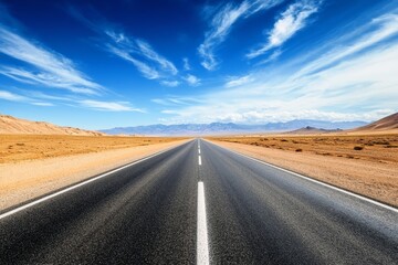 Fototapeta premium A long empty road stretching through a desert landscape.