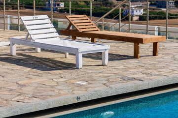 pool in resort, terrace with sofas and sun loungers by the pool