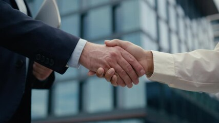 Close up unrecognizable multiracial business meeting in city colleagues Caucasian businessman man male guy African woman businesswoman girl female handshaking shake hands formal greeting hold folder - Powered by Adobe
