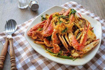 Fried crab in yellow curry, stir-fried crab curry in white plate