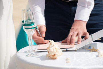 Decorations for wedding in the beach, Accessory kit bottles with sand for a wedding is on the table on the coastline of caribbean sea