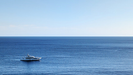 Fototapeta premium Yacht on sea bay on sunset, horizontal skyline view, top side aerial view, Majorca island, Spain