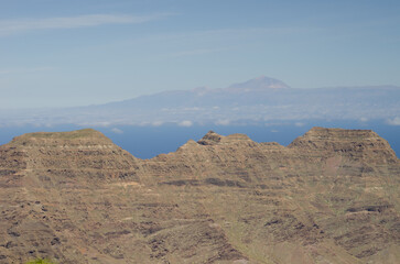 Cliffs in the Special Natural Reserve of Guigui and island of Tenerife in the background. Gran Canaria. Canary Islands. Spain.