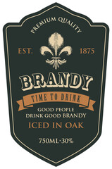 Monochrome vector label for brandy for bottle with fleur de lis on a black backdrop in a curly frame. Figured label or sticker for a strong alcohol drink in retro style isolated on white © paseven