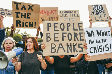 Crowd of multiracial people protest against inflation and financial crisis - Protesters marching...