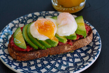 A delicious and healthy avocado toast topped with perfect poached eggs.