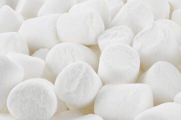 Background of white mini marshmallows. Top view. Completely in focus. View from an angle.