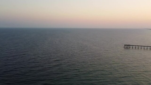 Aerial view of Navarre pier at sunset, Navarre Beach along Florida's Gulf Coast. Navarre Beach pier's is famous. is being longest fishing pier in Florida, 1,545 feet long 30 feet above water florida