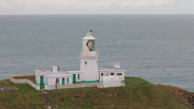 Strumble head lighthouse aerial view towards tower beacon on Pembrokeshire rugged island mainland
