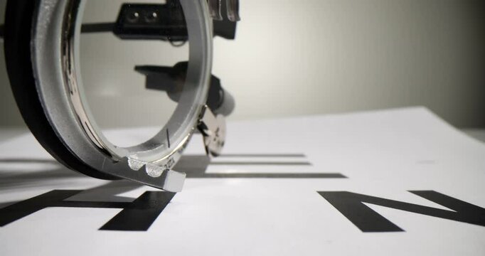 Optometry eyeglasses for fitting lenses with chart for focusing reading and eye examination. Optics medicine for myopia vision and vision examination