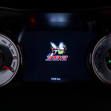 Dodge Challenger Scatpack 392 digital gauge cluster displaying bee logo, Sportscar interior detail