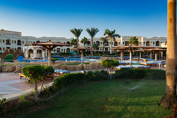 Swimming pool with palm trees at morning,  Egypt