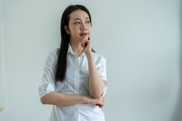 Young asian woman thinking with hand on chin