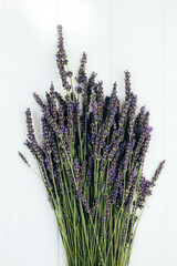 Bouquet of fresh lavender on a woodden background. Blooming background. Card for congratulations. Top view