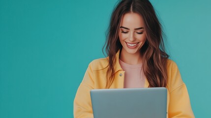 A woman smiles while working on a laptop in a bright and colorful space during the daytime
