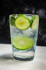 a glass of cold soda water and slices of lime