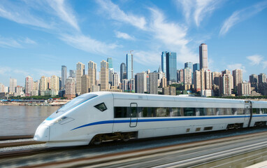 Obraz premium High-speed rail speeds on Bridges and the modern city skyline of chongqing, China