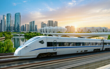 Naklejka premium High-speed rail speeds on Bridges and the modern city skyline of hangzhou, China