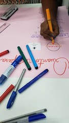 Various math activities on the table, some notebooks and markers