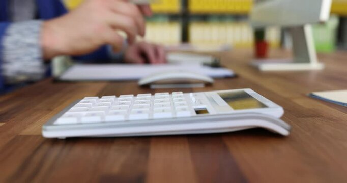 Businessman hands doing calculation of expenses and income of business writing down report. Project profitability debit and credit and accounting