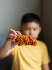 boy eating fried chicken.