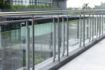 A glass railing with a view of a city street