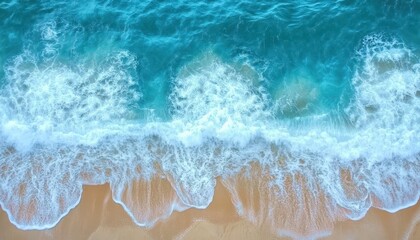 Obraz premium Aerial view of turquoise ocean waves gently crashing on a sandy beach