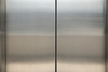 The silver doors of an elevator are closed.