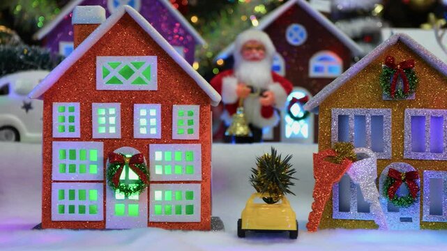 Close-up of a large Christmas town with cars, a chapel and Santa Claus