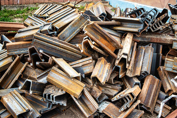 Storage of metal scraps for recycling at a manufacturing plant, showcasing the remnants of production piled high under clear skies