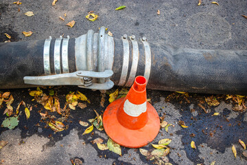 Fototapeta premium Corrugated pipe for waste water pumping in the city during maintenance to prevent sewage accidents on the streets