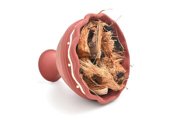 SIDE VIEW OF DHUNUCHI ON ISOLATED WHITE BACKGROUND WITH SELECTIVE FOCUS. INDIAN PUJA EQUIPMENT.