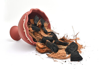 CLOSE UP VIEW OF DHUNUCHI WITH BURN COCONUT HUSK ON ISOLATED WHITE BACKGROUND.