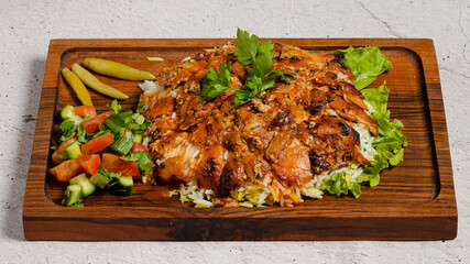 Portion doner kebab with rice on wooden tray