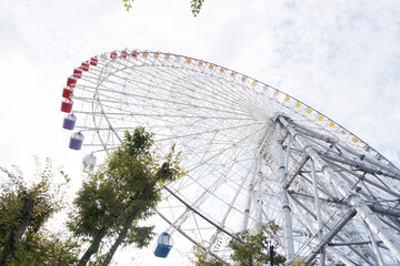 Fototapeta premium Ferris wheel on sky background, view from below